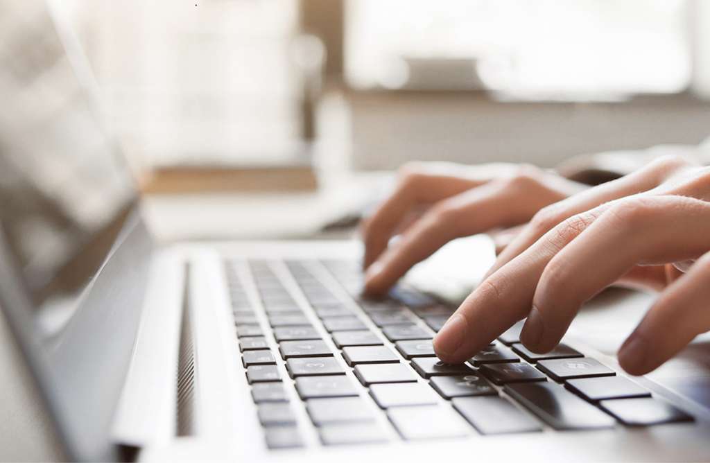 person typing on laptop